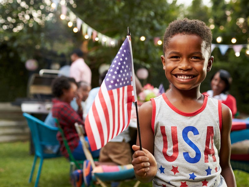 Boy Holding The Great American Flag Image